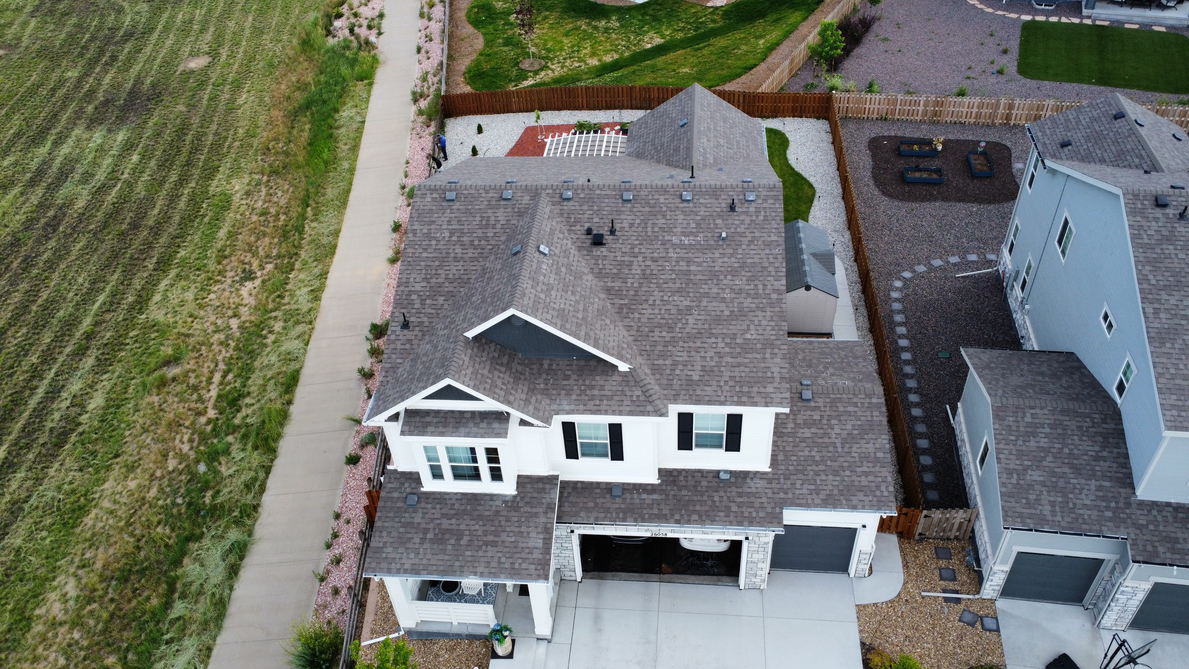 Close-up aerial of a residential roofing project with detailed workmanship