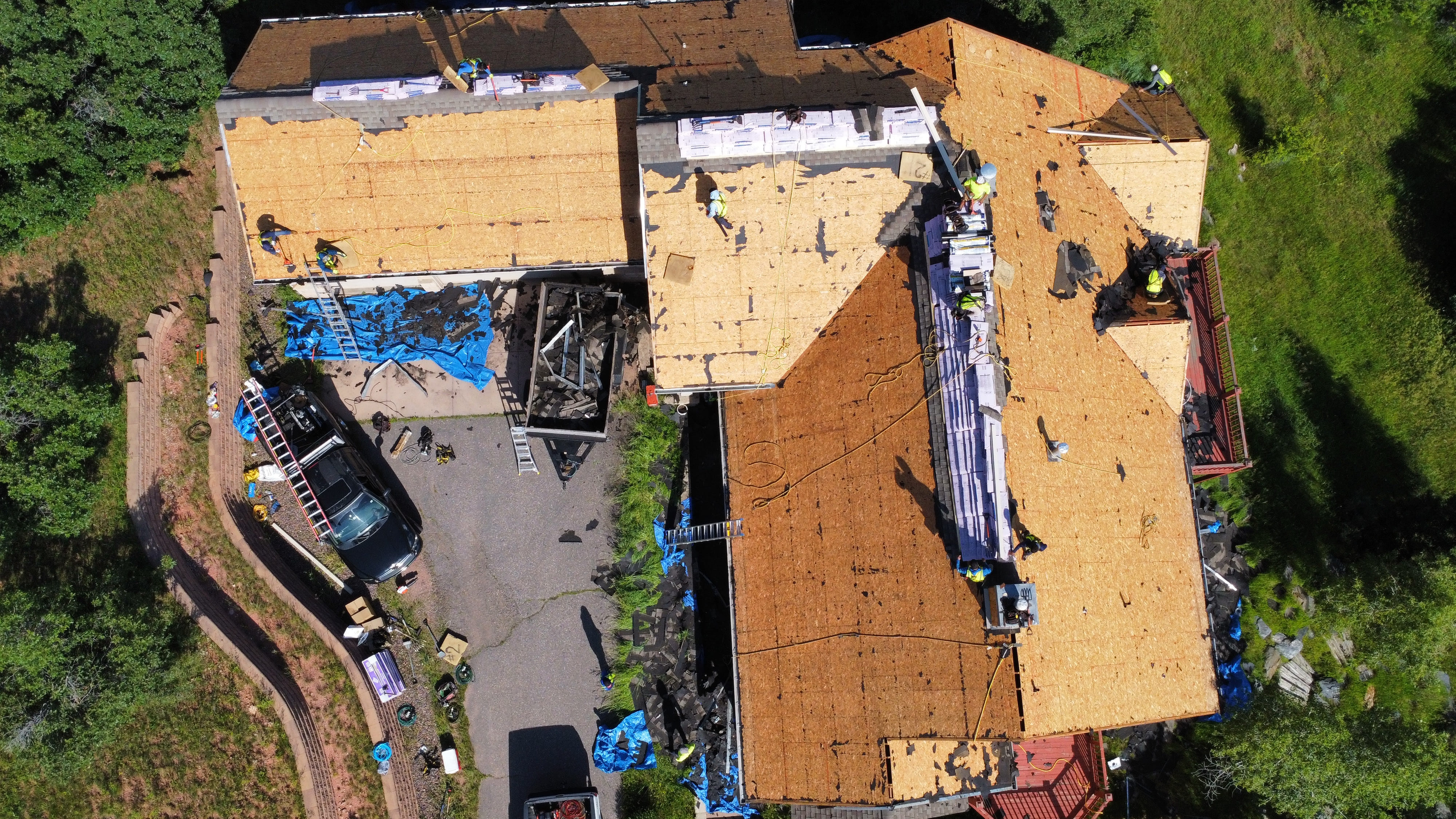 Large residential property with several roof sections being replaced
